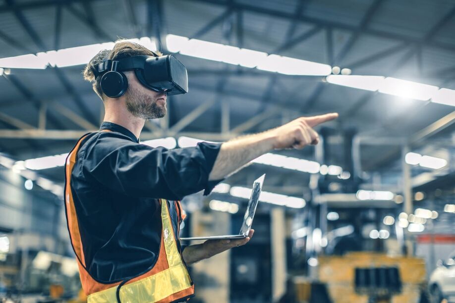 A man uses IoT technology for business in a factory.