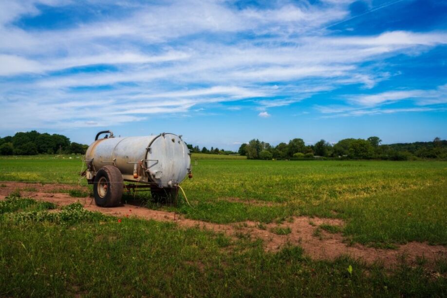 A tank that benefits from tank level monitoring sits in a field.